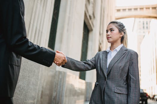 Image of a contractor shaking hands with a satisfied client