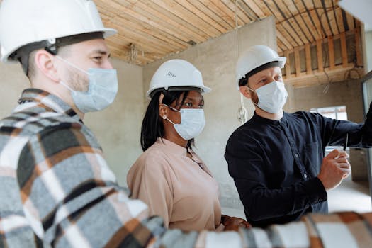 construction site with workers discussing plans